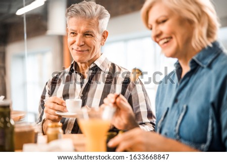Smiling adult man and woman spending time in cafe stock photo