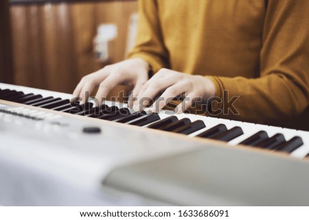 Man plays the piano, musical art, soft focus, vintage tinted