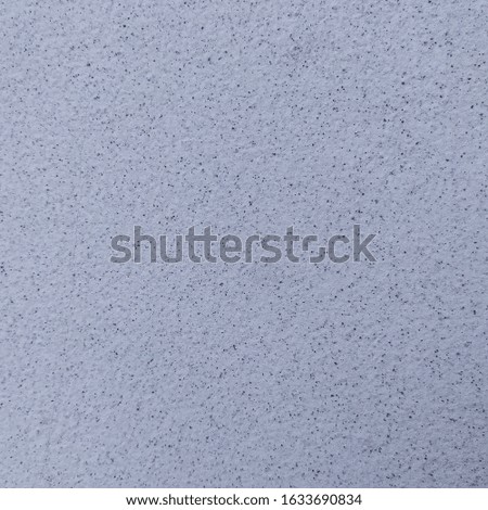 Gray white cement wall mixed with black sand.