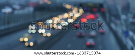 Defocused photography of traffic on the city street. Road if filled out by cars. Rush hours. Bright lifestyles of big city concepts. Soft blue colors and background. High angle view / top view. 