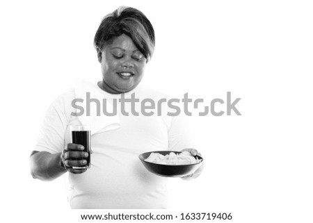 Studio shot of overweight African woman ready for gym