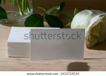 empty business card with white paper blank for design text message of contact your name and job description put on wooden office table