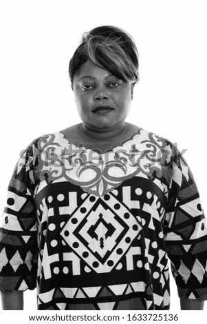 Studio shot of overweight African woman looking at camera