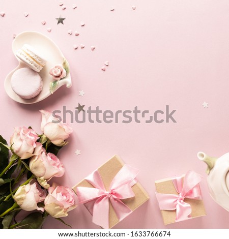 Gift box or gift box and flowers on pink table top view. Flat lay. Birthday, wedding, valentines day, march 8th concept. Place for your text. square.