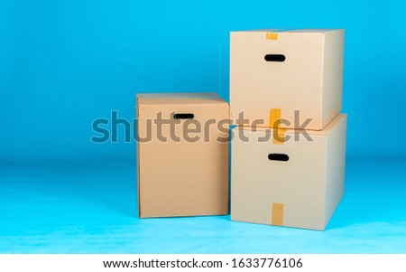 Stack of cardboard boxes on blue background