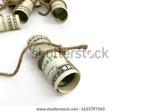 Closeup money rolled by hemp rope. Concept of chasing money.
