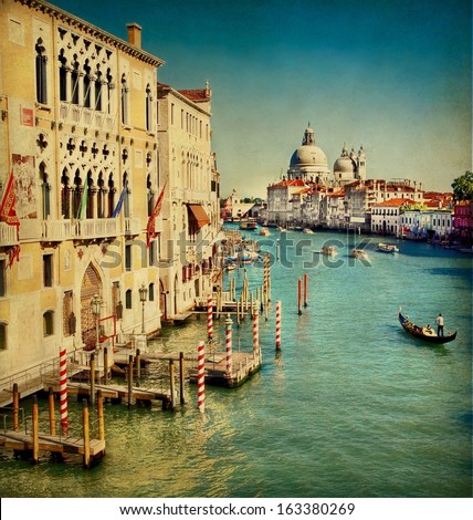 Vintage edited image from the Grand Canal of Venice with the famous landmark cathedral Santa Maria della Salute at the background 