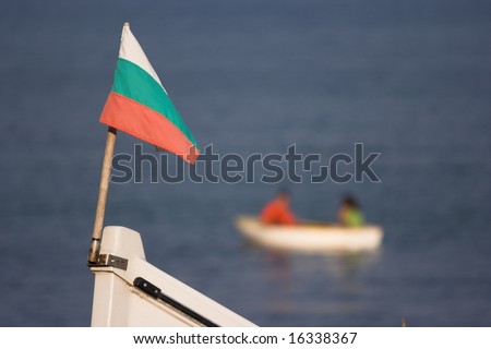 Couple in rowboat serve as a background to Bulgarian flag at bow