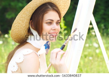 young woman with white canvas outdoors