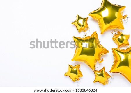 Air golden balloons star shape and candy on a white background. Concept for holiday, party, photo zone, decoration. Banner Flat lay, top view