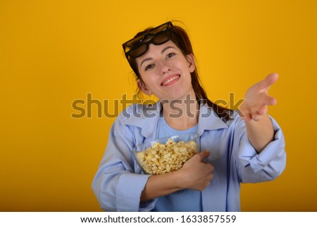 woman with popcorn on a yellow background