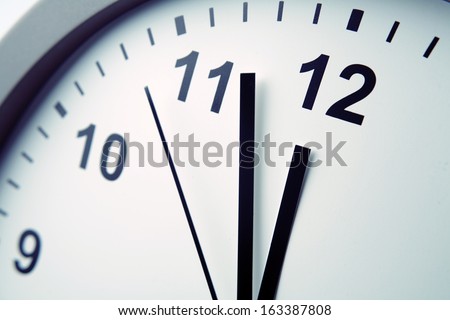 Closeup of hands on clock face Royalty-Free Stock Photo #163387808