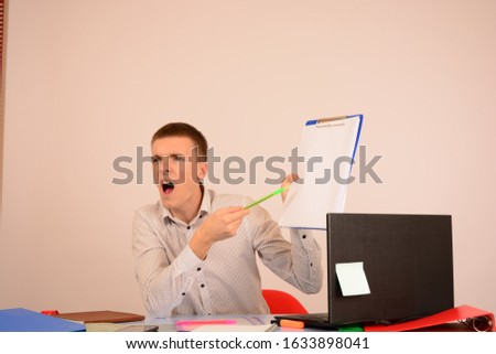 business man shouting points to a place a free folder tablet