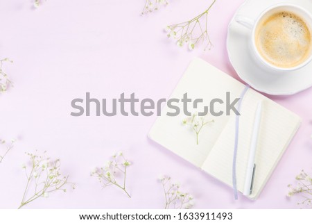 Good morning concept - coffee, flowers, notebook, pink background top view