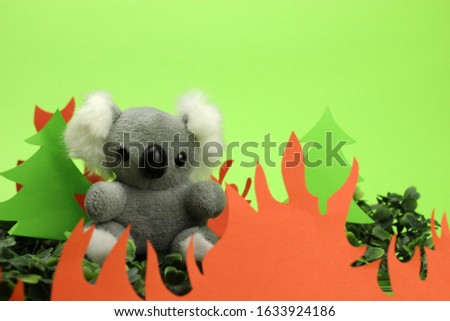Koala toy on the background of fire. Pray for Australia.