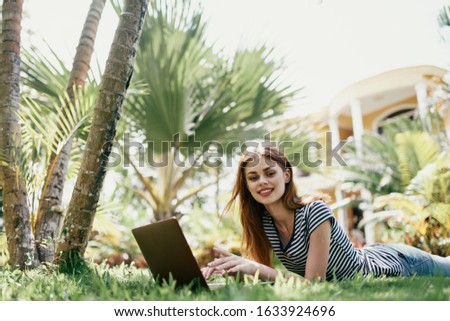young woman with laptop outdoors