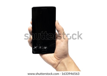 Closeup of a male hand, holding a smartphone with cracked screen, isolated on white background.