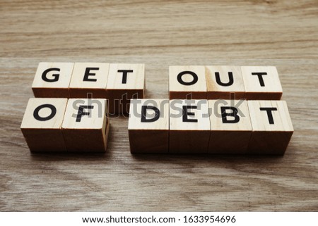 Get Out Of Debt alphabet letters on wooden background