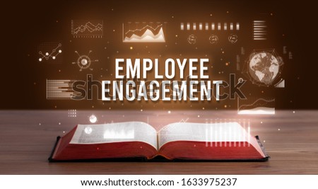 EMPLOYEE ENGAGEMENT inscription coming out from an open book, creative business concept