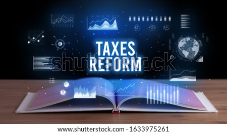 TAXES REFORM inscription coming out from an open book, creative business concept