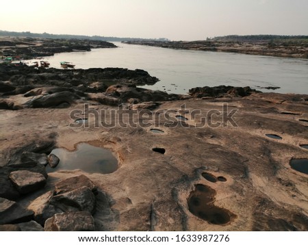 The rock that was hit by a whirlpool flows to Cebu to become a basin under the Mekong River in Thailand. Royalty-Free Stock Photo #1633987276