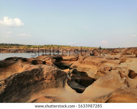 The rock that was hit by a whirlpool flows to Cebu to become a basin under the Mekong River in Thailand. Royalty-Free Stock Photo #1633987285