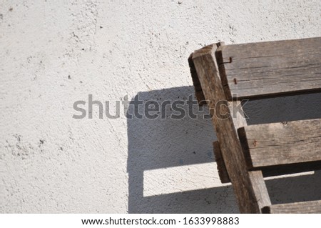 Gray wall texture and wooden object