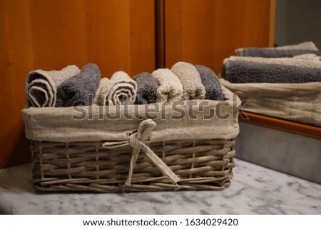 Basket with bath towels, in a bathroom