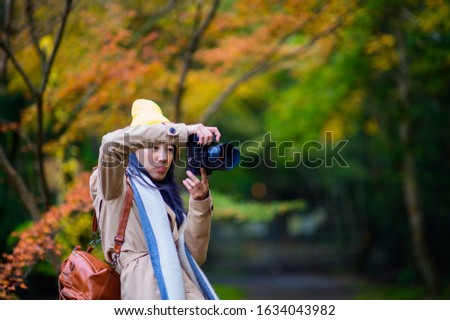 Woman traveller tourist enjoy takes photo, to see the scenery view of autumn village in Japan countryside, Autumn season change blooming on popular and famous place for tourist visit Japan 