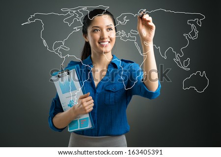 Isolated image of a young businesswoman pointing with a pen at the world map on digital interface 