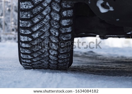 Wheel of car is coated in winter tires in snow. View from the front.