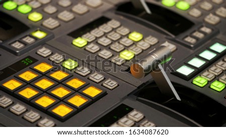 Blur image video switch of Television Broadcast, working with video and audio mixer, control broadcasts in recording studio. Broadcasting in the studio, professional mixing sender color buttons.