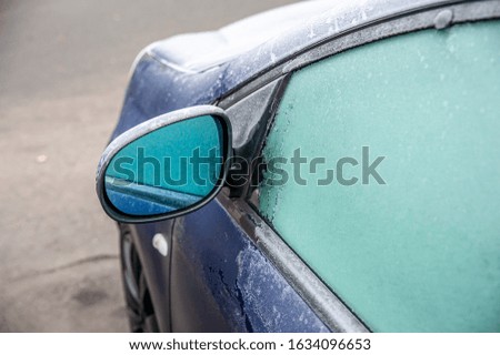 Closeup of frozen car window and mirror on a cold winter day