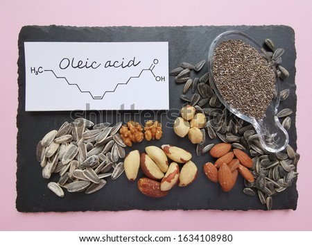 Structural chemical formula of oleic acid, an omega-9 fatty acid, with natural sources of oleic acid. Foods rich in oleic acid: sunflower seed, chia seed, Brazil nut, walnut, hazelnut, and almond. Royalty-Free Stock Photo #1634108980