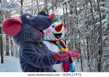 Animators in textile mouse and snowman costume. Symbol 2020 year.