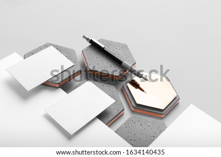 Real photo, stationery branding mockup template to place your design, isolated on light grey background, with concrete, copper, granite and floral elements.