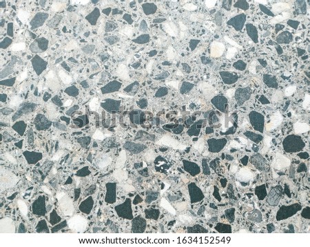 Tile sample looking like tiny pieces of rocks and stones are glued together creating a smooth surface for home interior or exterior decoration design