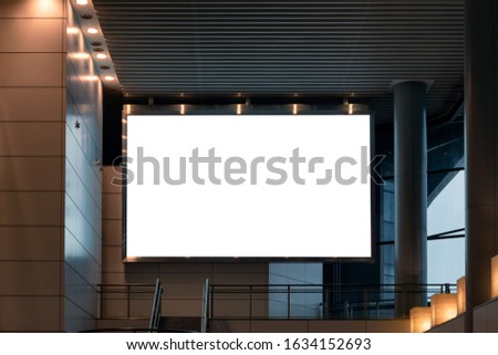 Large blank billboard with lighting setting on modern building