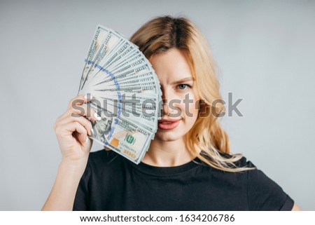 Woman showing  money real dollars on white background