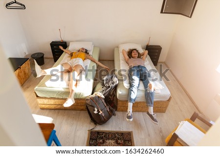 Young female tourists staying in youth hostel
 Royalty-Free Stock Photo #1634262460