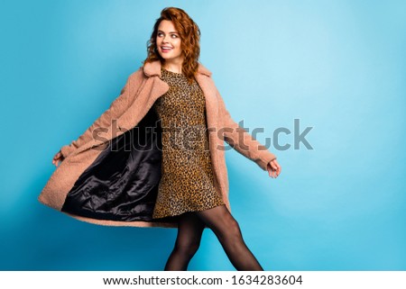 Portrait of candid satisfied womna look copyspace enjoy holiday weekend wear beige season outercoat tights isolated over blue color background