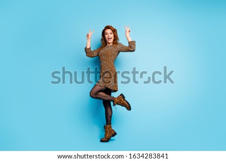 Full body photo of content candid woman enjoy fall winter free time make v-sings wear cotton tights boots isolated over blue color background