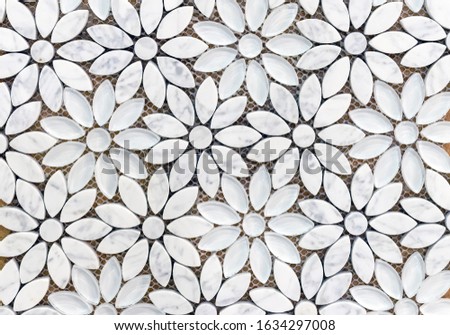 Marble tiles mosaic in the shape of flowers. Background of white marble flowers.