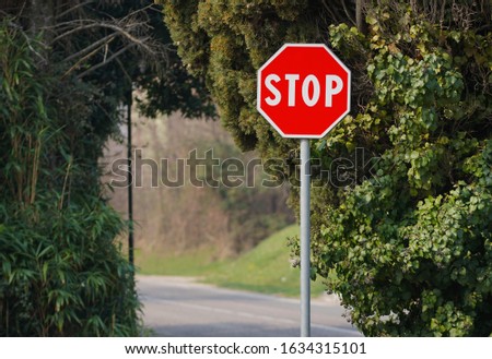 Isolated stop sign in front of a crossroad