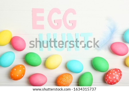 Easter eggs and the inscription "Egg hunt". Easter holiday background
