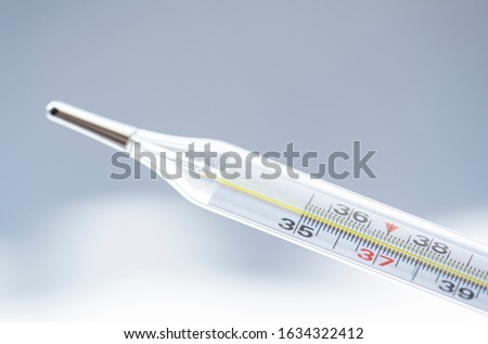 Close-up medical mercury thermometer on the white background.