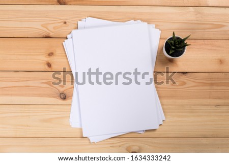 Top view of modern desk office workplace with  a4 paper. Blank branding template. Photo blank form. Mock up for portfolio design.