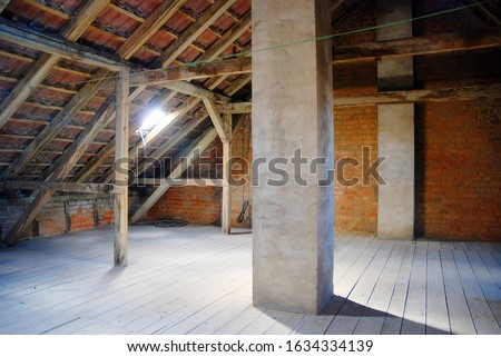 Old empty attic in a home waiting for renovation Royalty-Free Stock Photo #1634334139