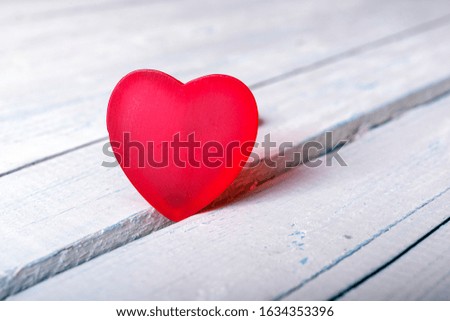Red heart on white painted rustic wooden background soft focus. Best concept of Valentines Day with copy space.