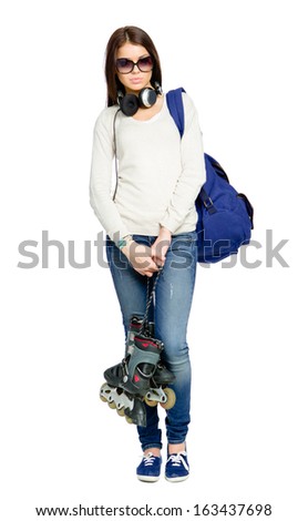 Full-length portrait of teenager with roller skates, rucksack and earphones wearing black sunglasses, isolated on white